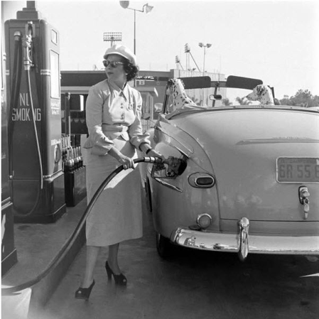 woman pumping own gas 1960s